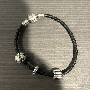 Pandora black braided bracelets with 2 charms and a spacer